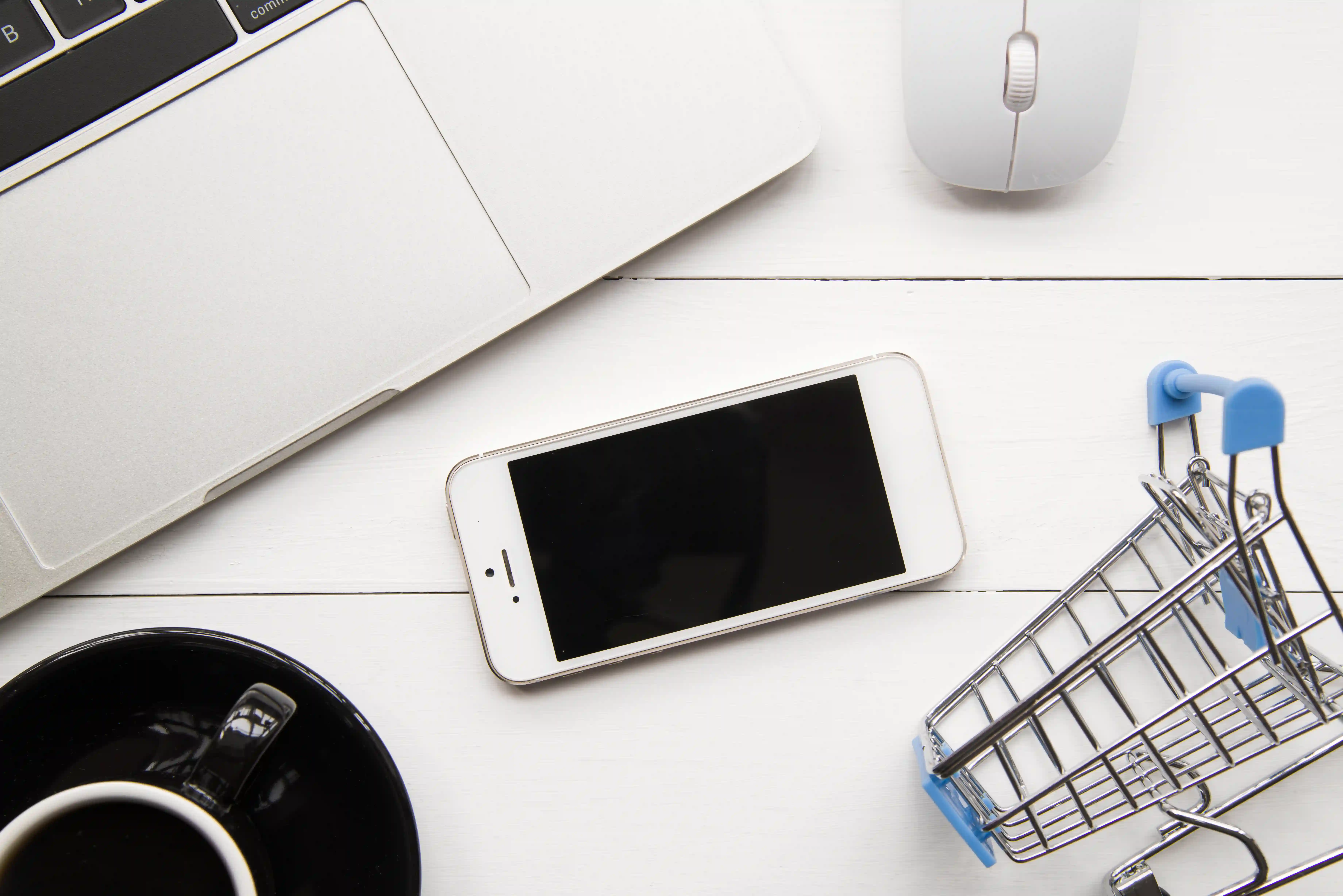1 smartphone-near-laptop-shopping-trolley
