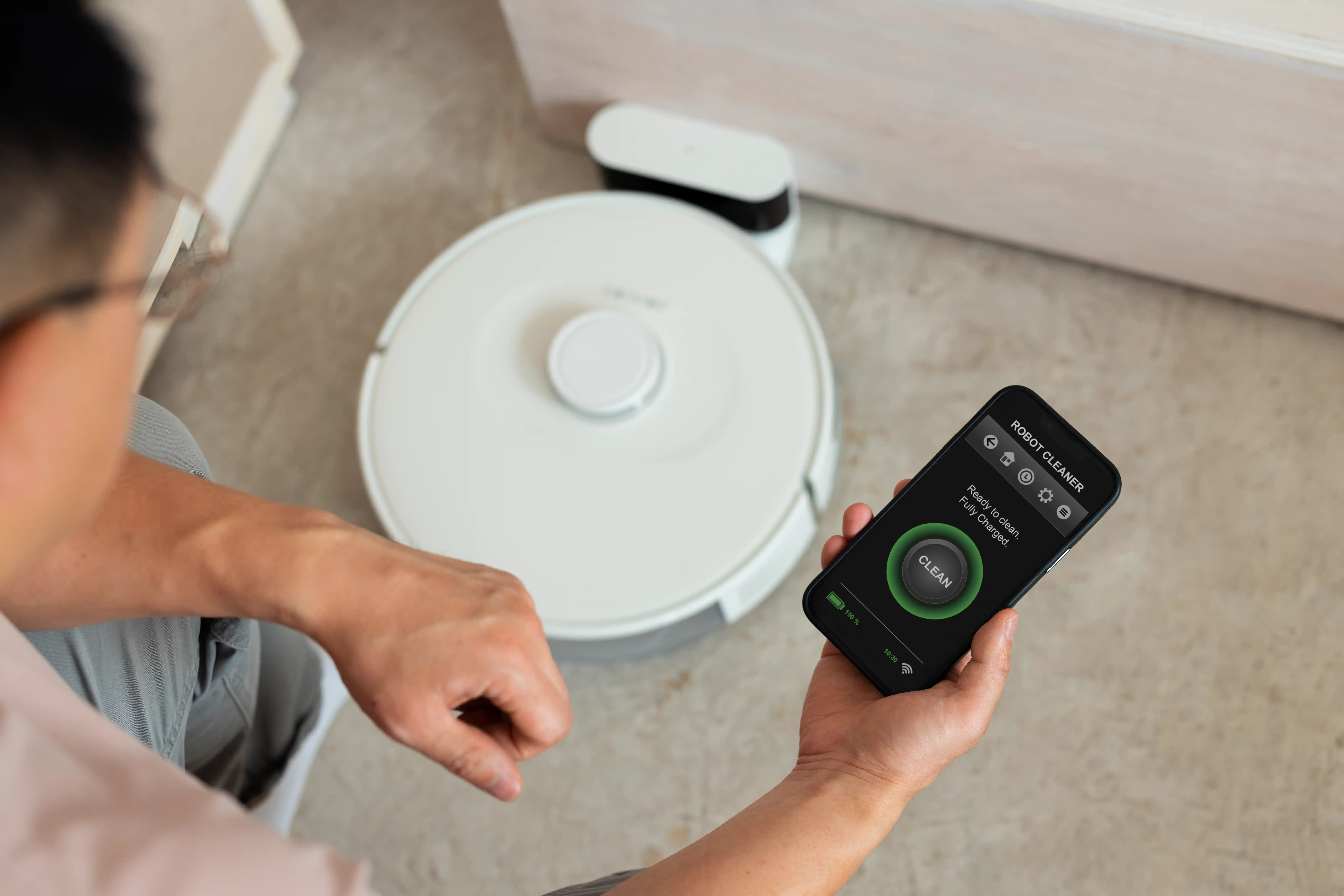 high-angle-man-with-robotic-vacuum-cleaner-home