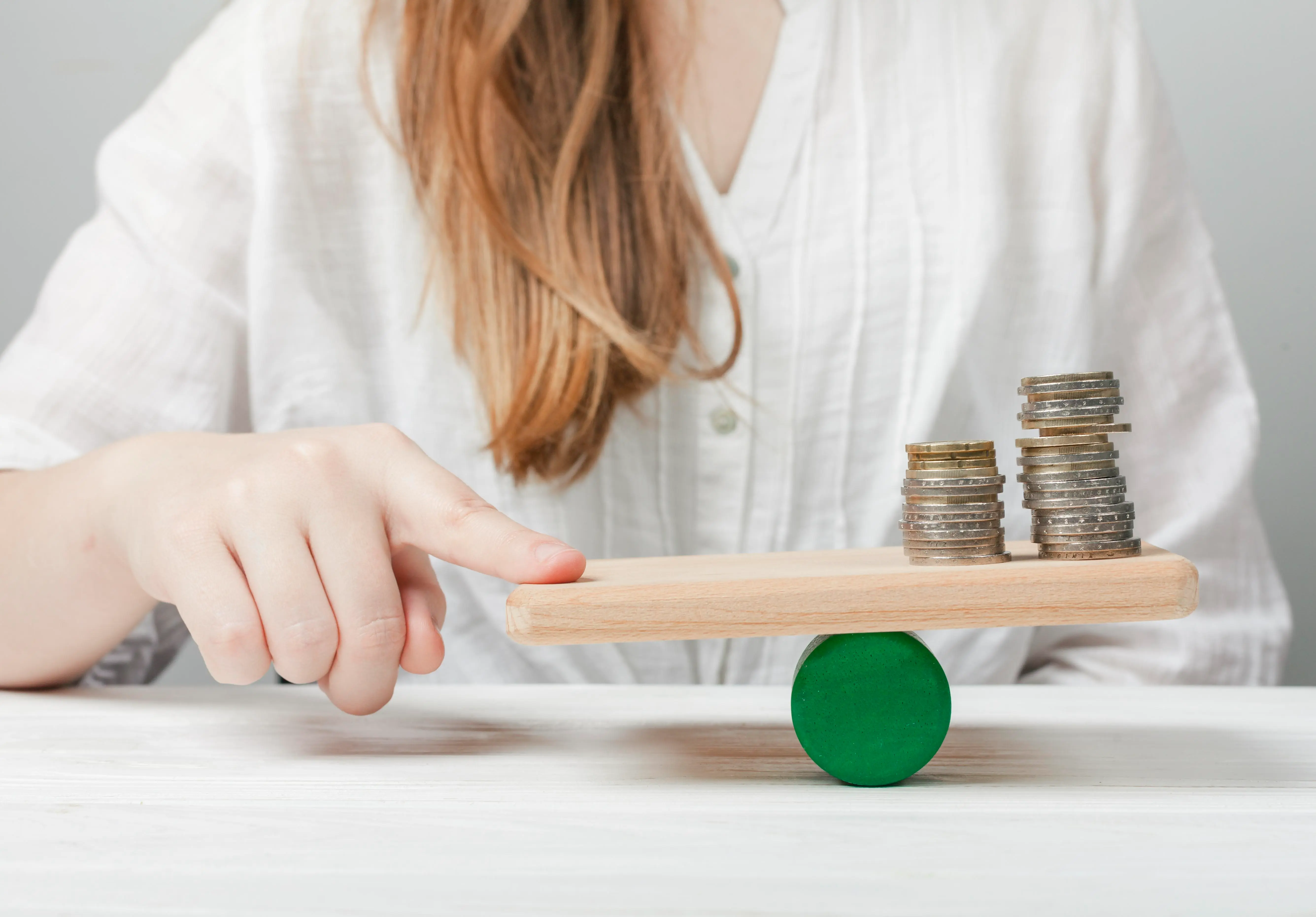1-woman-holding-her-finger-balance-with-coins